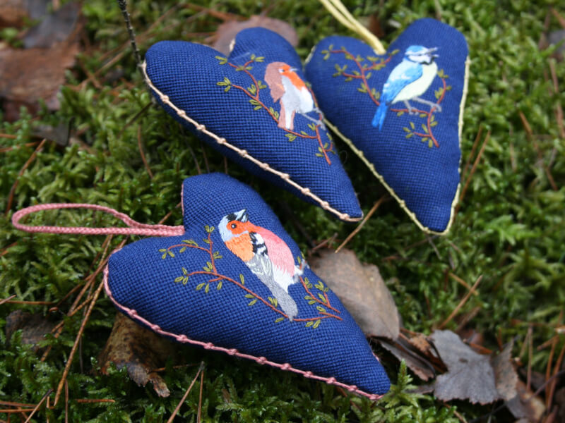 Birds embroidered on a heart shaped hanging decorations